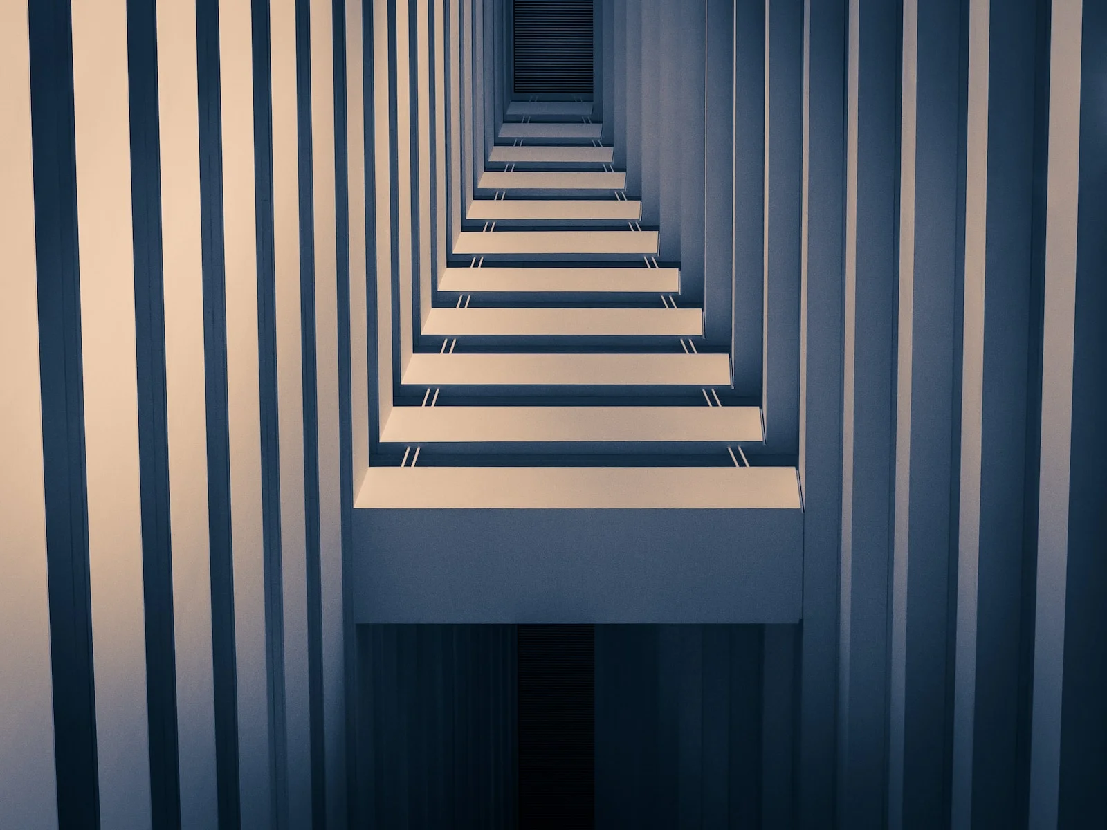 a row of stairs in a room with white walls